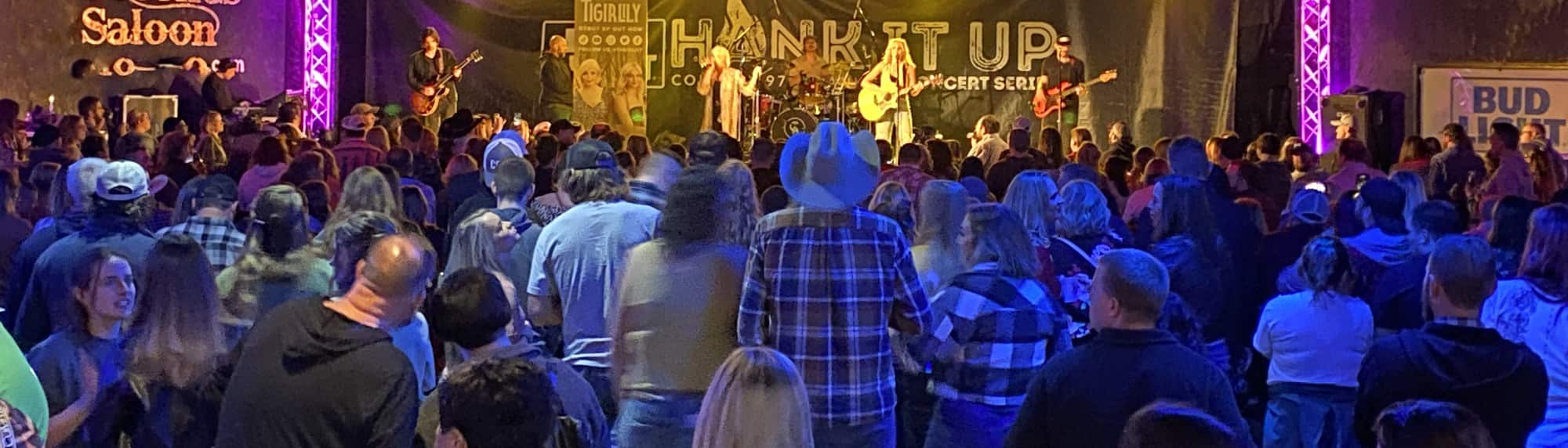 country concert with fans wearing cowboy hats Tuscaloosa