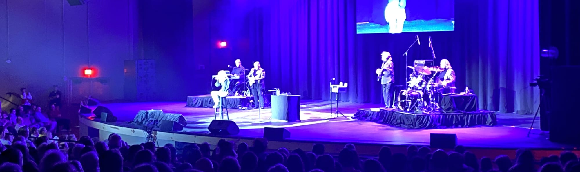 signer on stage in chair washed out by the lights Tuscaloosa